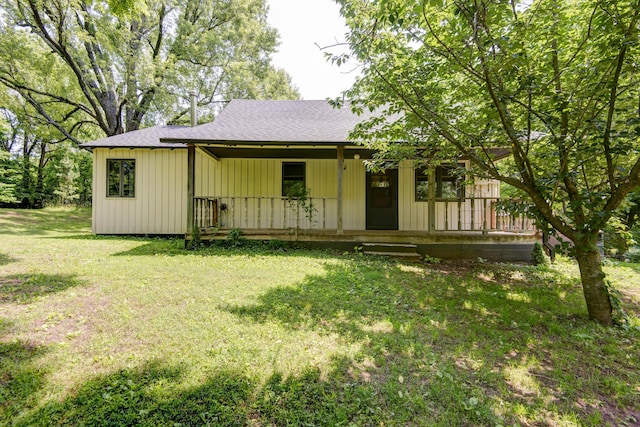 7692 N State Highway H, Springfield, MO 65803 - view of front of property with covered porch, a shingled roof, and a front yard