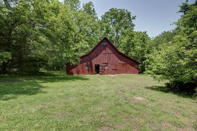 7692 N State Highway H, Springfield, MO 65803 - view of grassy yard with a barn, an outbuilding, and a forest view