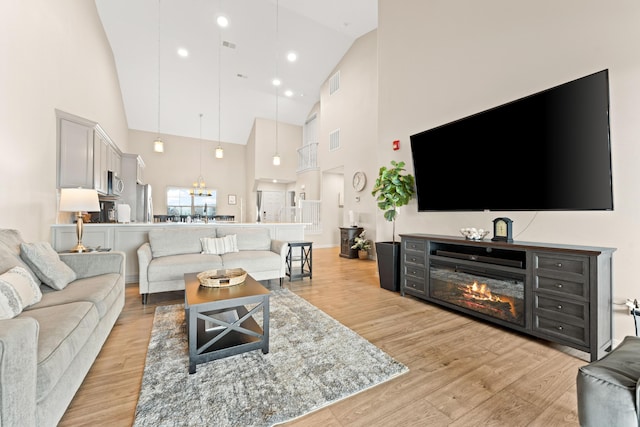 200 Majestic Dr # 423, Branson, MO 65616 - living area featuring high vaulted ceiling, light wood-style flooring, and baseboards