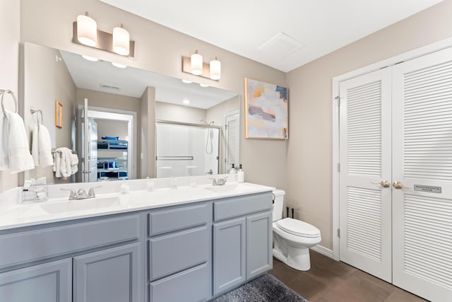 200 Majestic Dr # 423, Branson, MO 65616 - bathroom with a closet, a shower stall, double vanity, tile patterned floors, and toilet