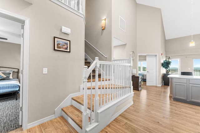 200 Majestic Dr # 423, Branson, MO 65616 - staircase with high vaulted ceiling, wood finished floors, and baseboards