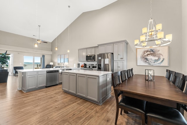 200 Majestic Dr # 423, Branson, MO 65616 - kitchen with appliances with stainless steel finishes, gray cabinetry, high vaulted ceiling, a chandelier, and light countertops