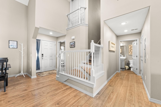200 Majestic Dr # 423, Branson, MO 65616 - foyer entrance featuring light wood-style floors, baseboards, a towering ceiling, and stairs