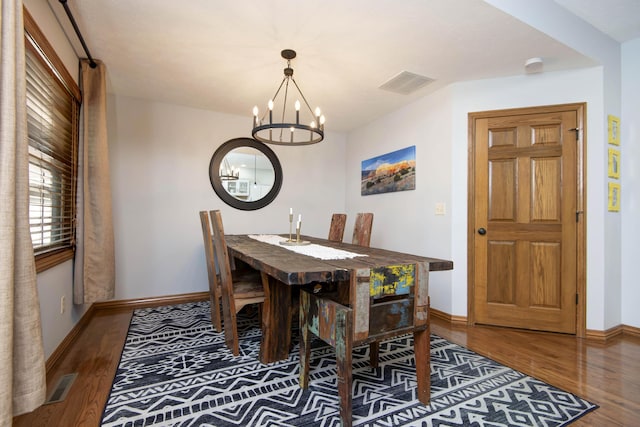 5052 E Cherry Pl, Springfield, MO 65809 - dining room featuring a chandelier, wood finished floors, and baseboards