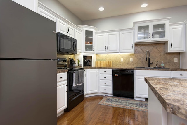 5052 E Cherry Pl, Springfield, MO 65809 - kitchen featuring black appliances, a sink, white cabinets, dark wood-style flooring, and recessed lighting