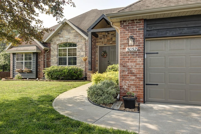 5052 E Cherry Pl, Springfield, MO 65809 - doorway to property with an attached garage, a lawn, stone siding, and a shingled roof
