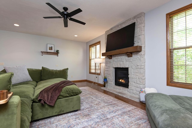 5052 E Cherry Pl, Springfield, MO 65809 - living area featuring wood finished floors, a stone fireplace, ceiling fan, baseboards, and recessed lighting