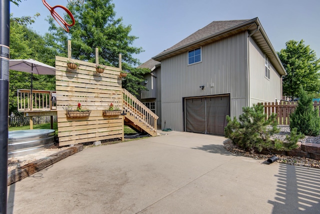 5052 E Cherry Pl, Springfield, MO 65809 - view of side of home with stairway, a garage, and driveway