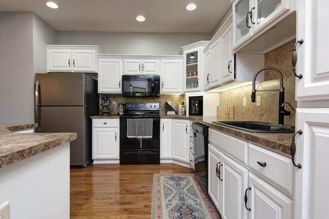 5052 E Cherry Pl, Springfield, MO 65809 - kitchen with black appliances, a sink, white cabinets, and recessed lighting