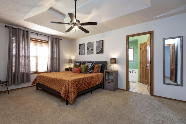 5052 E Cherry Pl, Springfield, MO 65809 - bedroom featuring light colored carpet, a raised ceiling, baseboards, connected bathroom, and ceiling fan