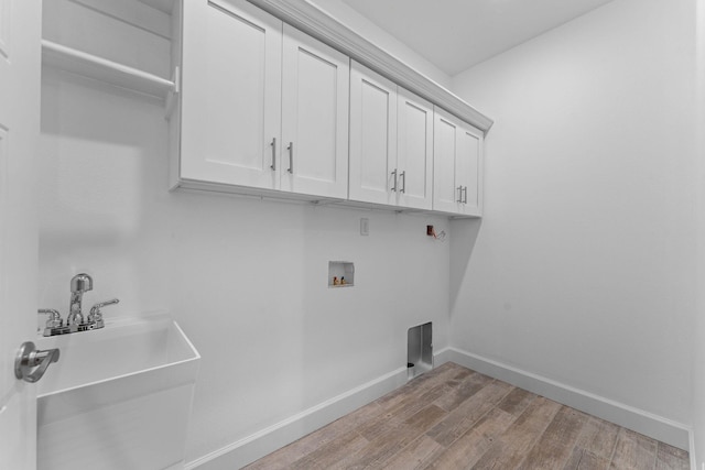 680 Highpoints Rdg, Branson, MO 65616 - laundry room featuring cabinet space, washer hookup, wood finished floors, and baseboards