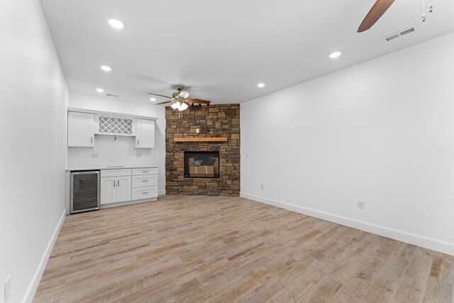 680 Highpoints Rdg, Branson, MO 65616 - unfurnished living room featuring ceiling fan, beverage cooler, bar area, light wood-type flooring, and recessed lighting