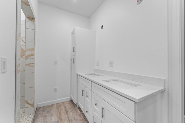680 Highpoints Rdg, Branson, MO 65616 - bathroom featuring double vanity, wood finished floors, baseboards, and a marble finish shower