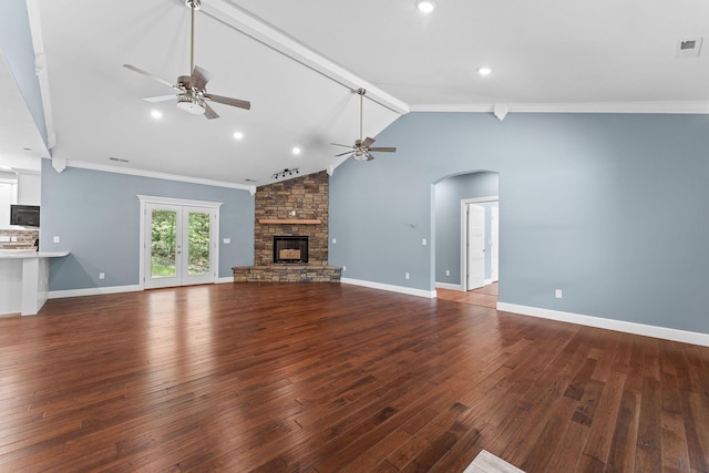 680 Highpoints Rdg, Branson, MO 65616 - unfurnished living room featuring ceiling fan, arched walkways, hardwood / wood-style floors, a stone fireplace, and baseboards