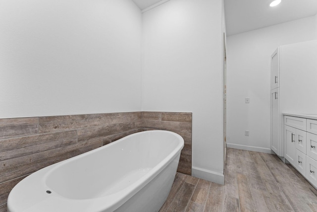 680 Highpoints Rdg, Branson, MO 65616 - bathroom featuring a soaking tub, wood finished floors, recessed lighting, and baseboards