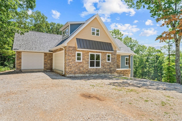 680 Highpoints Rdg, Branson, MO 65616 - view of front of property featuring stone siding, an attached garage, dirt driveway, a standing seam roof, and a shingled roof