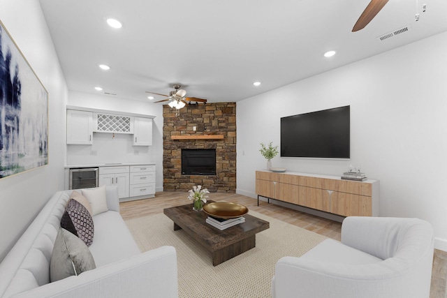 680 Highpoints Rdg, Branson, MO 65616 - living area featuring ceiling fan, beverage cooler, light wood-type flooring, bar with sink, and recessed lighting