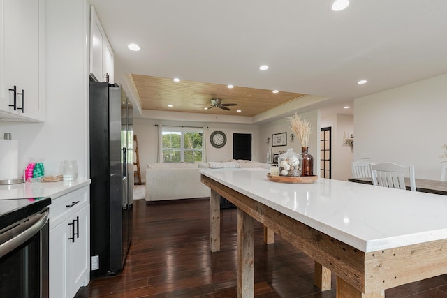 777 S Elm St, Marshfield, MO 65706 - kitchen with stainless steel fridge, open floor plan, a breakfast bar, a raised ceiling, and dark wood finished floors