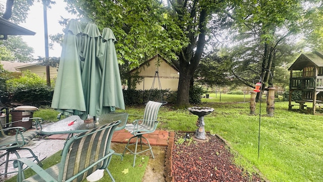 1361 E Dunkirk St, Springfield, MO 65804 - view of grassy yard featuring a patio and a playground