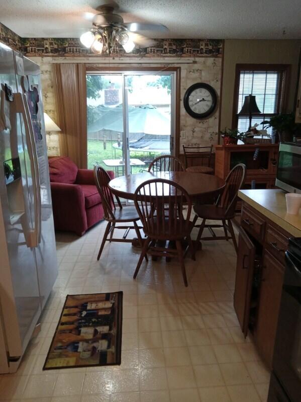 1361 E Dunkirk St, Springfield, MO 65804 - dining area with ceiling fan, light floors, and a textured ceiling