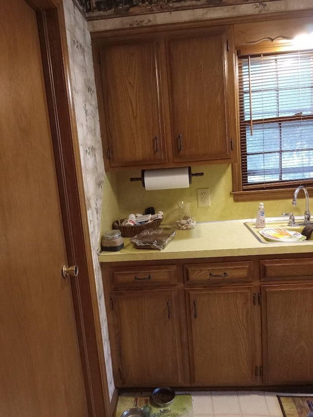 1361 E Dunkirk St, Springfield, MO 65804 - kitchen with light countertops, brown cabinetry, and light tile patterned floors