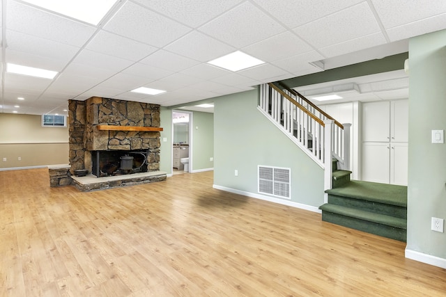 13544 State Highway Kk, Marshfield, MO 65706 - unfurnished living room with stairway, wood finished floors, a fireplace, and a paneled ceiling