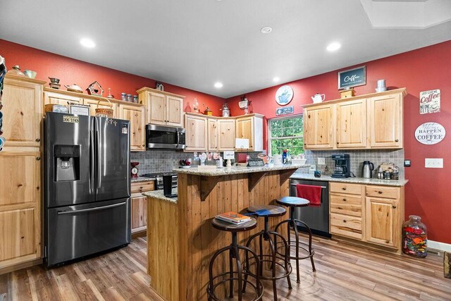 6 Glory Ln, Blue Eye, MO 65611 - kitchen with appliances with stainless steel finishes, light brown cabinetry, light wood finished floors, and recessed lighting