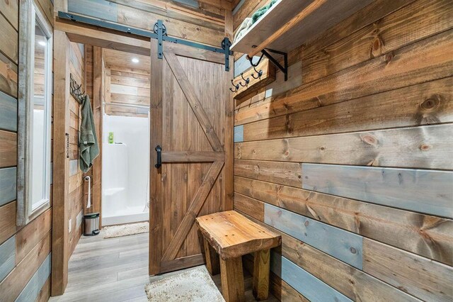 6 Glory Ln, Blue Eye, MO 65611 - mudroom with a barn door, wooden walls, and wood finished floors