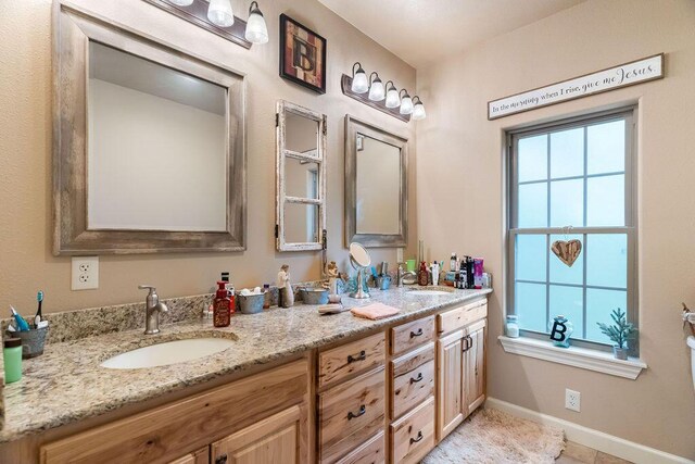 6 Glory Ln, Blue Eye, MO 65611 - bathroom with double vanity and baseboards