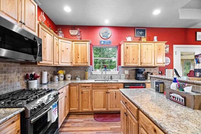 6 Glory Ln, Blue Eye, MO 65611 - kitchen with stainless steel microwave, gas range, a sink, light wood-type flooring, and backsplash
