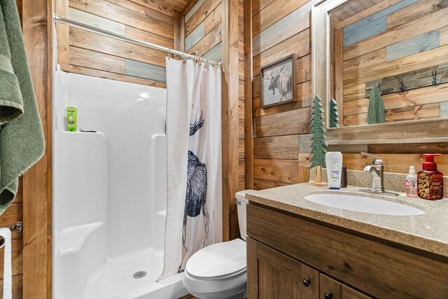 6 Glory Ln, Blue Eye, MO 65611 - bathroom with wooden walls, vanity, toilet, and a stall shower