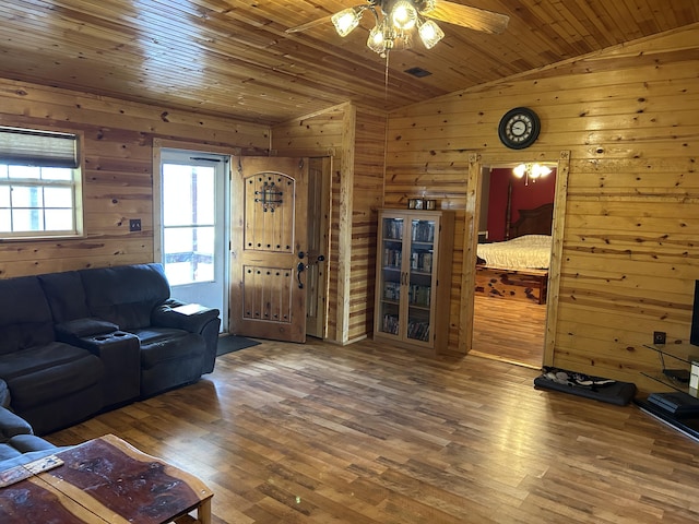 23700 E State Highway 76, Rocky Comfort, MO 64861 - living area featuring lofted ceiling, wooden walls, a ceiling fan, wood finished floors, and wooden ceiling