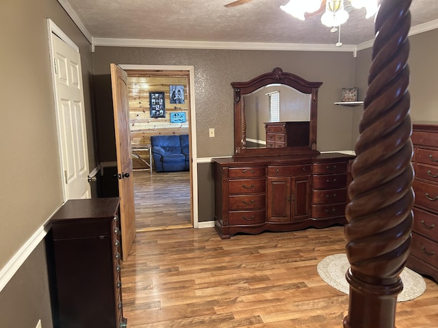 23700 E State Highway 76, Rocky Comfort, MO 64861 - bedroom with wood finished floors, crown molding, a textured ceiling, ceiling fan, and a textured wall