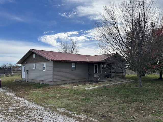 23700 E State Highway 76, Rocky Comfort, MO 64861 - view of home's exterior featuring a trampoline and metal roof