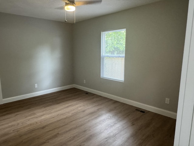 1922 S Village Ln, Bolivar, MO 65613 - unfurnished room with ceiling fan, dark wood-type flooring, and baseboards