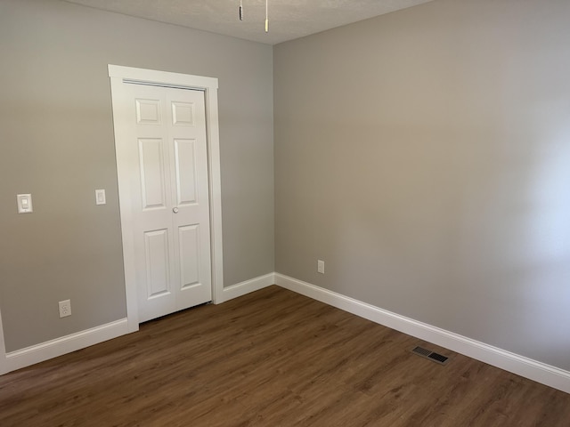 1922 S Village Ln, Bolivar, MO 65613 - unfurnished room with dark wood finished floors and baseboards