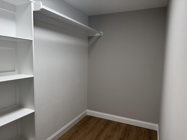 1922 S Village Ln, Bolivar, MO 65613 - spacious closet featuring dark wood finished floors