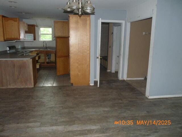 1098 Sundown Ln, Forsyth, MO 65653 - kitchen featuring a chandelier, a sink, dark wood finished floors, baseboards, and range