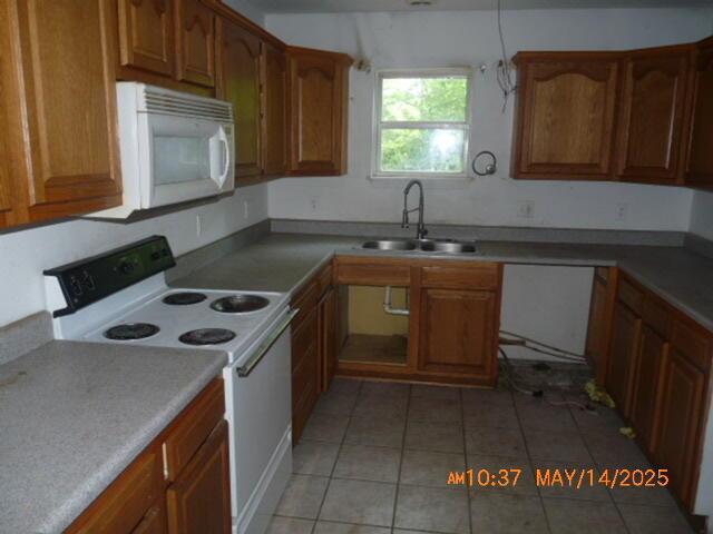 1098 Sundown Ln, Forsyth, MO 65653 - kitchen with white appliances, a sink, light tile patterned flooring, and brown cabinetry