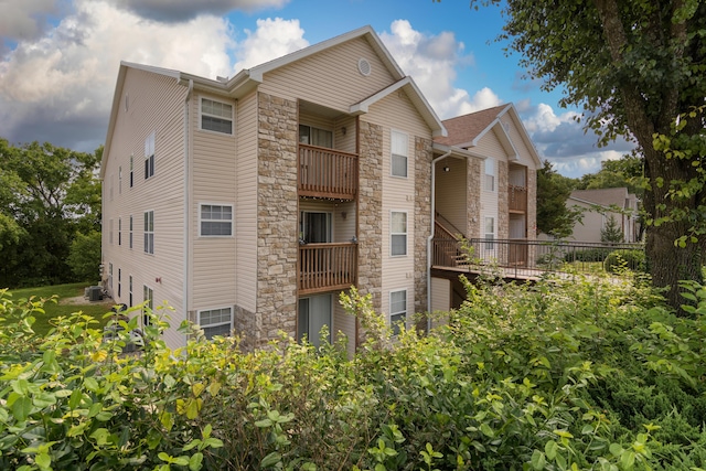 118 Vixen Cir Unit D, Branson, MO 65616 - view of property exterior with stone siding and central AC