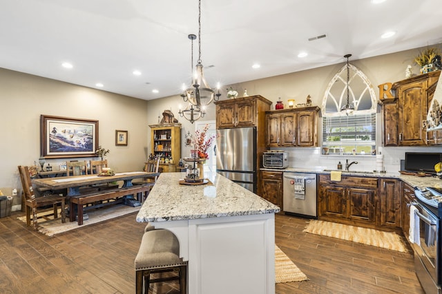 22 Kinder Ln, Rogersville, MO 65742 - kitchen featuring stainless steel appliances, dark wood-type flooring, backsplash, a kitchen island, and recessed lighting