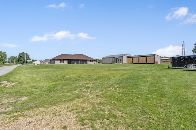 22 Kinder Ln, Rogersville, MO 65742 - view of green lawn with an outdoor structure and an outbuilding