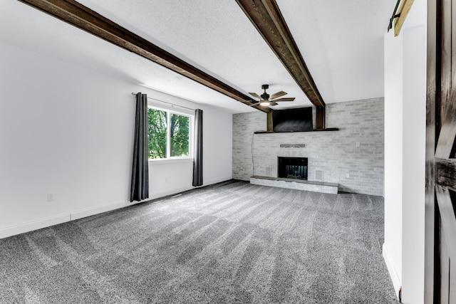 32 State Road F, Buffalo, MO 65622 - unfurnished living room featuring ceiling fan, a fireplace, carpet floors, beamed ceiling, and baseboards