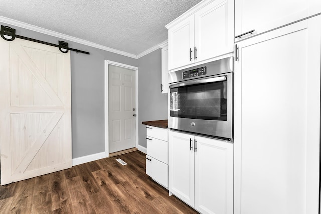 32 State Road F, Buffalo, MO 65622 - kitchen featuring stainless steel oven, dark wood-style flooring, dark countertops, a textured ceiling, and baseboards