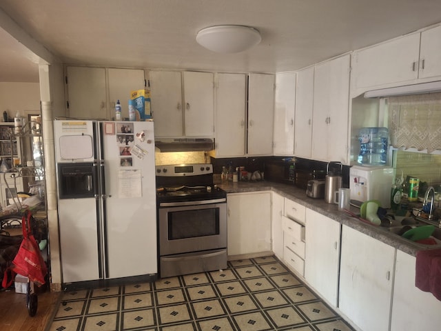 1224 Columbus St, West Plains, MO 65775 - kitchen featuring stainless steel electric range oven, freestanding refrigerator, under cabinet range hood, white cabinets, and dark countertops