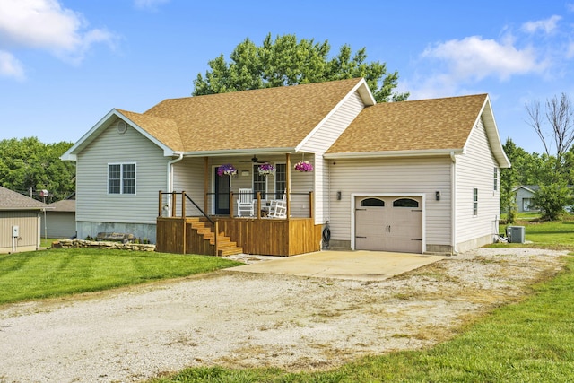 1427 W Missouri St, Buffalo, MO 65622 - view of front of house with a garage, dirt driveway, roof with shingles, covered porch, and a front yard