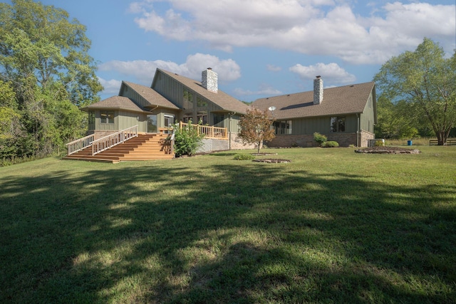 561 E Spring St, Neosho, MO 64850 - back of property with board and batten siding, a lawn, a deck, and a chimney