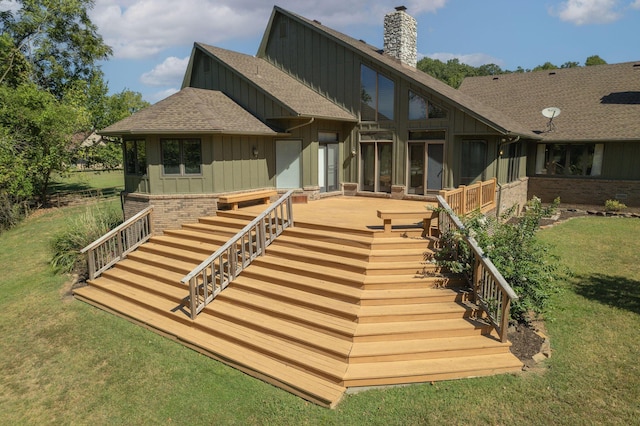 561 E Spring St, Neosho, MO 64850 - rear view of house with stairway, board and batten siding, a chimney, a shingled roof, and a lawn