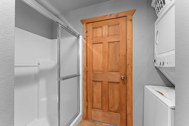41 Stepping Stone Way Unit 55, Branson West, MO 65737 - washroom featuring estacked washer and dryer and light tile patterned floors