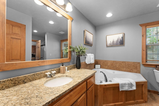 41 Stepping Stone Way Unit 55, Branson West, MO 65737 - bathroom with vanity, toilet, a garden tub, and recessed lighting